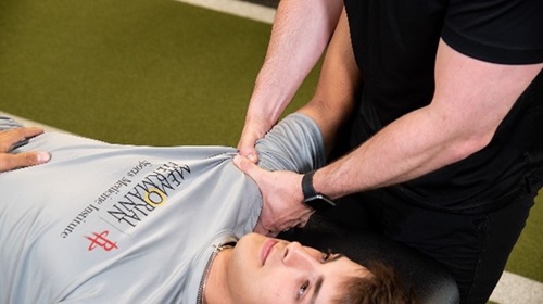 Person stretching patients arm