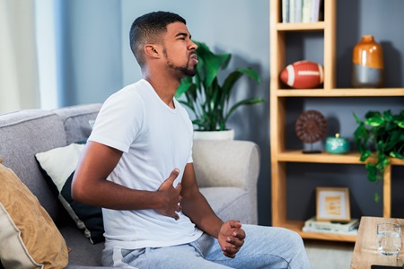 Man holding their stomach in pain.