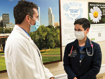 Affiliated physicians, Dr. Argy Stampas, MD, MS from physical medicine and rehabilitation meeting with hospitalist, Dr. Gina Khraish, MD.