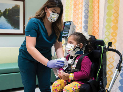 Claudia Huerta assists a pediatric patient at TIRR Memorial Hermann.