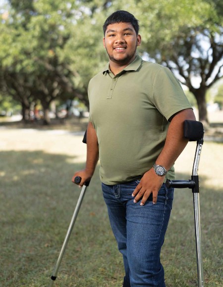 Following rehabilitation at TIRR Memorial Hermann, Himanshu Prasad stands proudly.