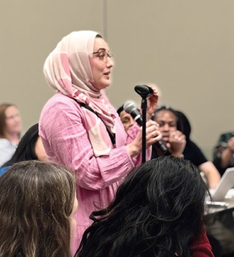 A conference attendee asks a question during the Cancer Rehabilitation Symposium (2025): Advancing Patient Centered Care Across the Cancer Continuum.