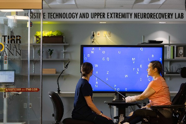 A TIRR Memorial Hermann patient uses technology in the Assistive Technology and Upper Extremity Neurorecovery Lab.