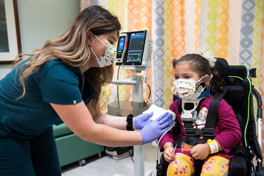 A child at TIRR Memorial Hermann is assisted by a therapist