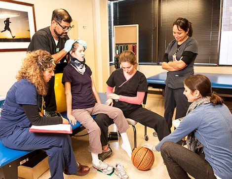 Woman going through rehabilitation with therapists