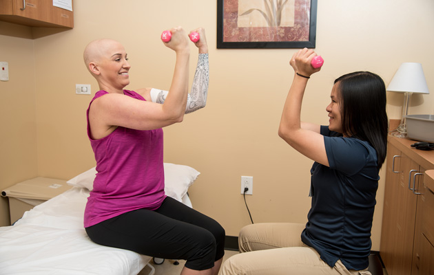 Leigh performs cancer rehab exercises