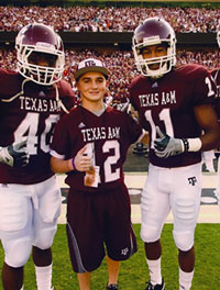 Teen posing with football players