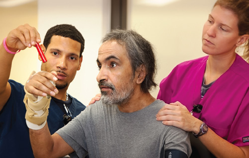 Man participating in therapy with therapists
