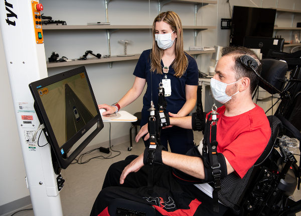 A TIRR Memorial Hermann patient uses assistive technology