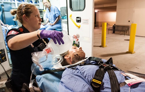 EMS helping a patient on stretcher
