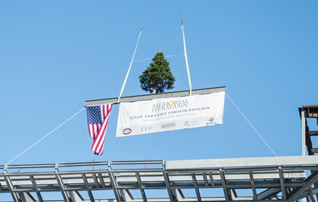 Tree being placed on the top of metal structure