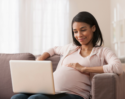 Pregnant woman at computer