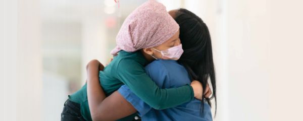Child hugging nurse