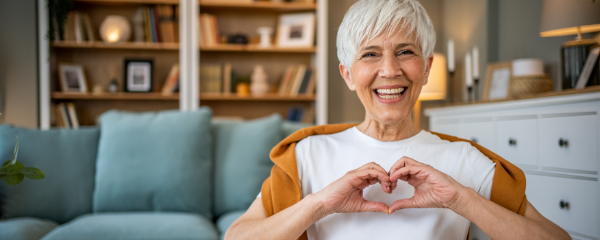 Older woman making heart with hands