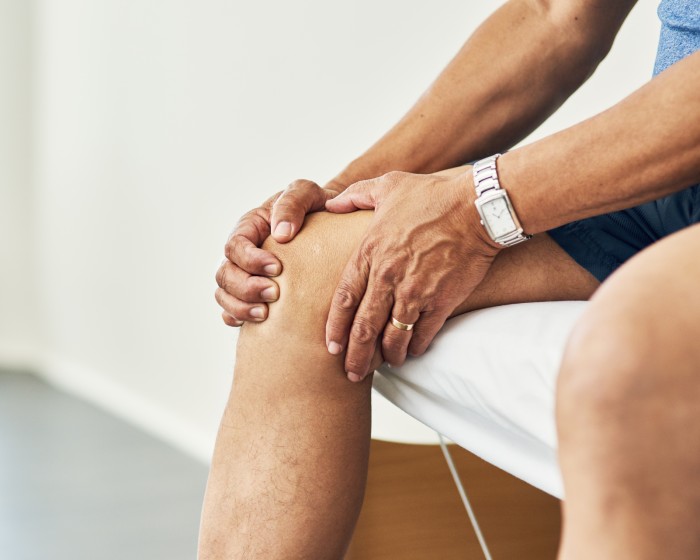 Patient holding knee in pain