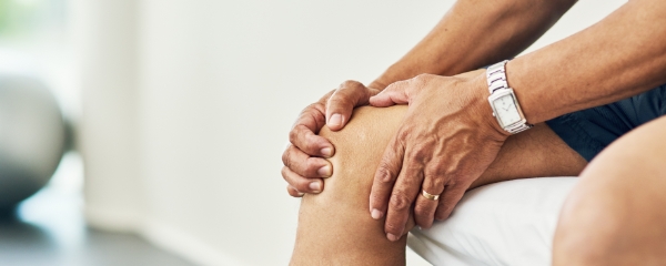 Patient holding knee in pain