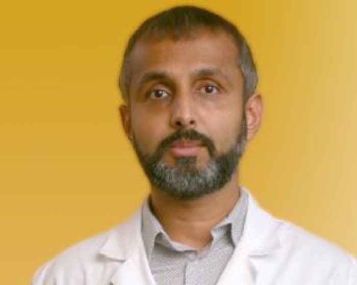 physician portrait on yellow background