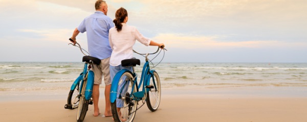 A couple on the beach with bikes