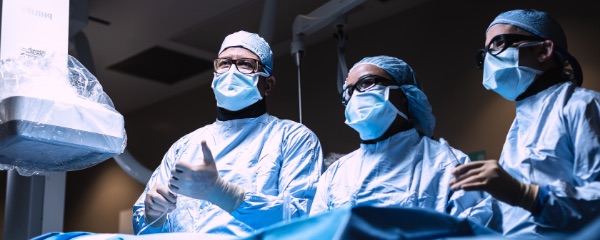 Three physicians in scrubs