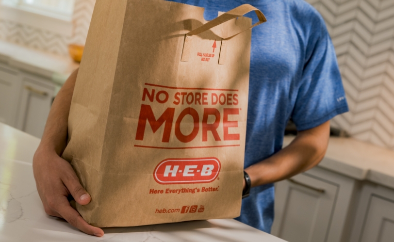 Man holding HEB grocery bag