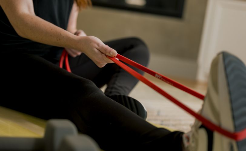 Woman stretching with resistance band