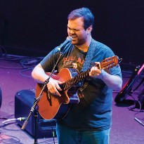 Former TIRR Memorial Hermann patient, Brandon Ray, sings on stage.