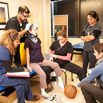 Patient receiving rehabilitation with therapists