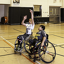 Two Boys Playing Basketball in Wheelchairs