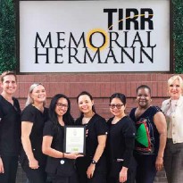 TIRR Memorial Hermann staff smile with their award.